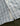 White and blue plaid short-sleeve shirt with button front and brand label visible on sleeve.
