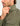 Man wearing sage green button-down shirt with chest pocket and icon logo detail.
