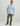 Man wearing light blue and white gingham button-down shirt with chest pocket and olive green pants.