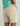 Huk men's Next Level 7-inch Short in Khaki, stain-release fishing shorts, back view, alternate angle