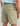 Huk men's Next Level 7-inch Short in Seagrass, stain-release fishing shorts, side profile view