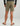 Tan textured shorts with back pockets and zip detail, shown on model from behind.