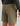Tan textured shorts with back pocket and drawstring waistband, displayed on model wearing dark patterned jacket.