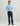 Navy flat-front pants with straight leg fit, shown on model with light blue quarter-zip pullover.