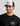 Huk men's Script Patch Trucker Hat in Heather Grey, moisture-wicking mesh-back trucker hat, front view, alternate angle