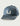 Slate blue baseball cap with cream "U" logo and perforated side panels.