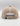 Beige mesh trucker hat with tan snapback closure and dark patch on crown, shown from rear view.