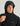 Black hooded jacket with front zip closure and adjustable drawstring hood, worn by male model.