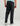 Black pants with elastic waistband and cuffed ankles, shown from back view on male model wearing light blue shirt.