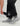 Black pant with side zip opening and velcro cuff detail, shown on model with gray and white booties.