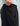 Black pants with elastic waistband, side zipper pocket, and drawstring detail worn with light blue long-sleeve shirt.