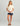 Cream short-sleeve tee with chest pocket and navy palm-print shorts.