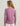 Woman wearing a mauve long-sleeve crew neck shirt with text on the back, shown from behind.