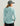 Light blue women's hoodie with textured fabric, shown from back view with hood down.