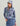 Woman wearing blue and pink abstract patterned hoodie with attached hood and matching baseball cap.