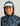 Woman wearing a blue and gray camo-patterned performance hoodie with a matching visor cap.