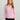Women's light pink long-sleeve pullover with quarter-zip front closure and mock neckline.
