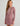 Red and white geometric patterned long-sleeve cover-up dress with white trim and drawstring hem detail.