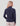 Woman wearing dark blue heathered half-zip fleece with raglan sleeves and cream pants, shown from back.