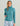 Teal heathered fleece hoodie with kangaroo pocket and tonal stitching detail worn with patterned shorts.