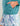 Teal heathered fleece hoodie with kangaroo pocket and HUK logo, worn with patterned shorts.