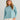 Woman wearing HUK Women's Leeward Boxy Fleece Hoodie in Reefline Heather