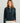 Woman wearing HUK Women's Camden Snap Fleece Pullover in Sea Storm Heather