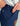 Navy shorts with zip fly and branded label, worn with gray zip-up hoodie.