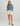Cream-colored volley shorts with drawstring waist and side pockets, paired with a blue hoodie.
