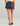 Navy swim shorts with blue botanical print and elastic waistband, worn with brown sandals.