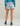 Light blue shorts with white and navy floral print, elastic waistband, paired with teal long-sleeve top.