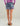 Women's short with purple, teal, and black abstract pattern, worn with pink long-sleeve top.