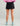 Huk women's Embark Skort in Black, stretch fishing bottoms, side profile view