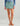 Huk women's Embark Skort in Mineral Blue, UPF 50+ sun protection fishing bottoms, front view, alternate angle