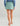 Huk women's Embark Skort in Mineral Blue, stretch fishing bottoms, side view