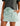 Huk women's Cruiser Skort in Heron Blue, stretch fishing bottoms, front view, alternate angle
