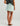 Huk women's Cruiser Skort in Heron Blue, stretch fishing bottoms, side view