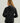 Black women's hooded jacket with gray inner collar shown from back view.