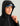 Black hooded jacket with blue visor and front zipper, shown on model wearing blue and black cap.