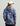 Women's jacket with purple, pink, and teal storm print pattern, shown from back view with hood.