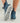 Women's slip-on boot in blue wave print with white sole, shown from side and bottom angles.
