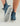 Women's slip-on boot in blue wave print with white sole, shown from side and bottom angles.