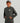 Child wearing charcoal gray long sleeve hoodie with small logo patch on chest and front kangaroo pocket.