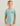 Boy wearing light blue t-shirt with red and blue comic-style graphic text on chest, paired with coral shorts.