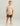 Young boy wearing beige t-shirt with orange logo and camouflage shorts.