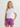 White short-sleeve tee with coral "huk" text on chest, worn with purple shorts.