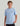 Boy wearing a light blue short-sleeve t-shirt with embroidered logo on chest and black shorts.