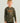Child wearing mossy oak camouflage long-sleeve crew neck shirt with orange HUK Performance Fishing logo and text.