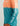 Coral and teal colorblock hoodie with jagged color-block line, HUK logo on chest, and "HUK Fishing" text on sleeve.