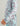 Child's hoodie with light blue and mauve camo pattern and white text down the sleeve.